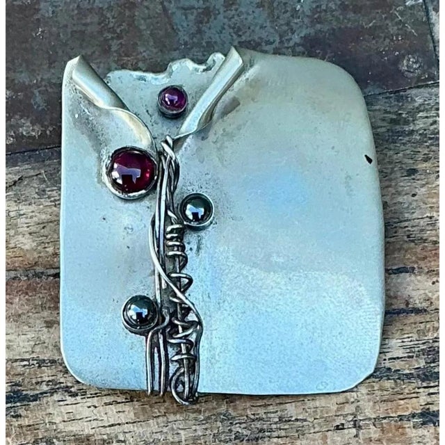 This vintage handmade sterling silver modernist brooch is a striking study in raw, artisan-forged form. A freeform silver...