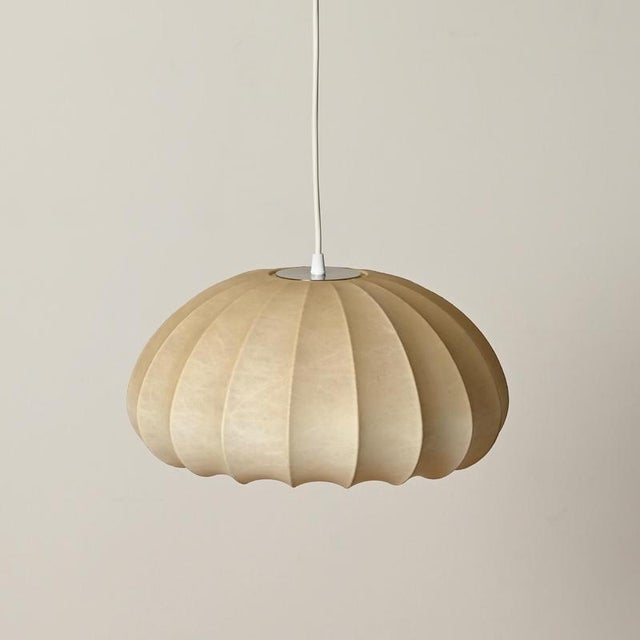 Wonderful mid-century dome-shaped cocoon pendant light in beige resin and steel. This gorgeous ceiling light was designed...