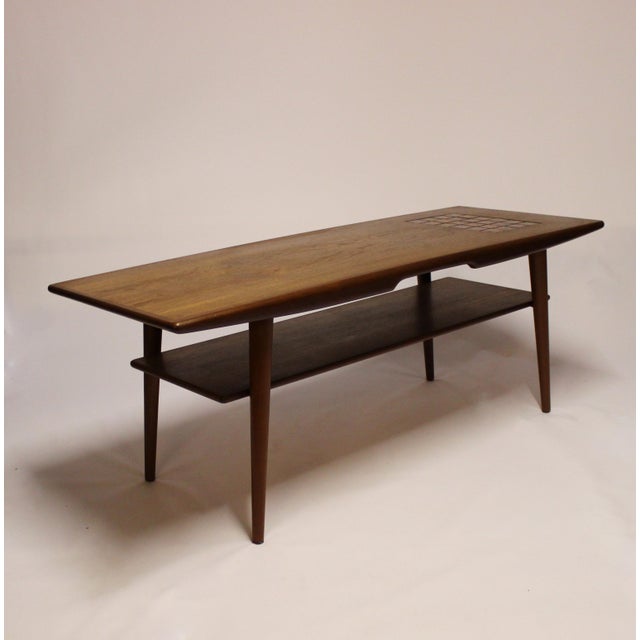 This Danish teak coffee table with dark-colored tiles was designed in the 1960s.