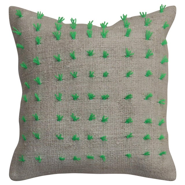 Pillow made from a vintage Turkish Kilim with green wool stitched on giving it a bohemian vibe. Zipper closure and foam...