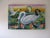 The artwork depicts a vibrant lagoon scene, featuring graceful swans gliding through water adorned with lily pads, while...