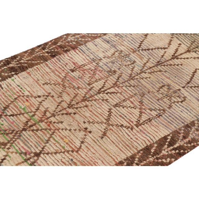 Hand-knotted in wool and originating from Morocco circa 1950-1960, this 4x5 vintage rug is a rare and among the most...