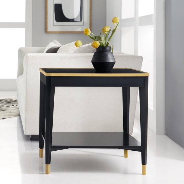 The clean-lined silhouette is beautifully accented with polished brass details, including a refined frame along the...