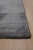 A 12' x 15' hand-knotted wool and viscose rug with a charcoal gray strie field with fine tonal streaks, in wool with...