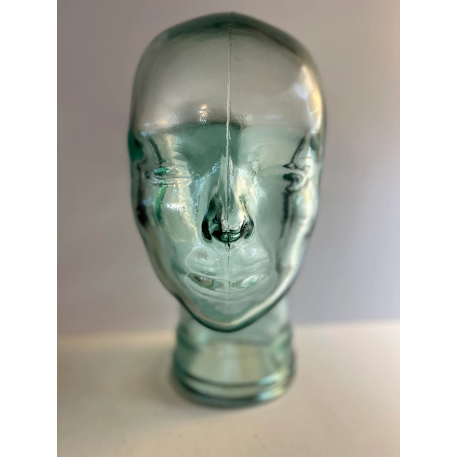 Vintage green glass mannequin head for hats and display. Mid-Century.