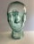 Vintage green glass mannequin head for hats and display. Mid-Century.