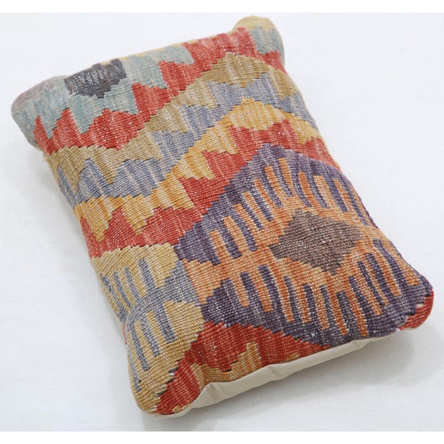 A one-of-a-kind handwoven Afghan wool kilim lumbar pillow featuring diagonal diamond bands. Cut and sewn by hand from a...