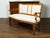 An Italian walnut settee from the 19th century, with curving back, scrolling arms and tapered feet. Created in Italy...