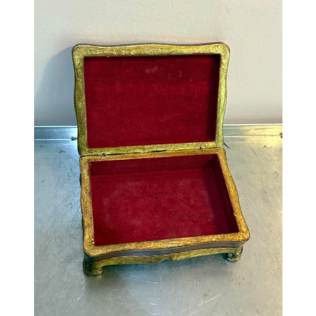 Florentine giltwood jewelry or trinket box w/ red velvet lining. Some very minor surface scratching in a few spots as...