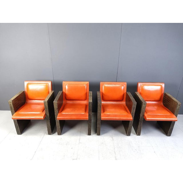 Unique vintage armchairs Stamped TIST Paris by Maison Vandamme. The chairs are made from orange leather with embossed faux...