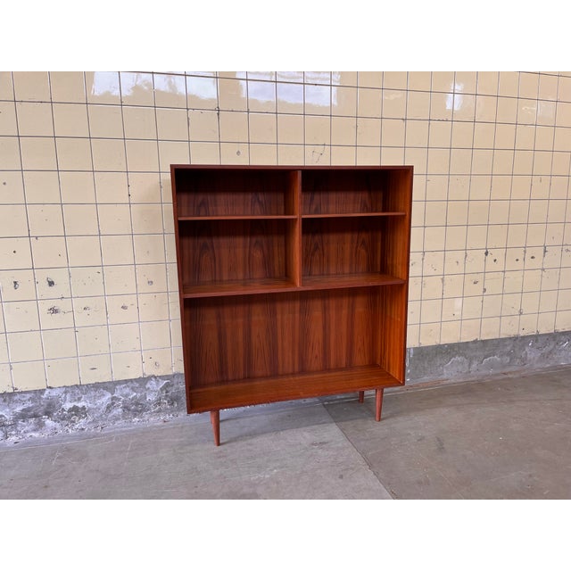 This Danish bookcase is crafted in warm teak and features a clean and beautifully balanced design. The large open space at...