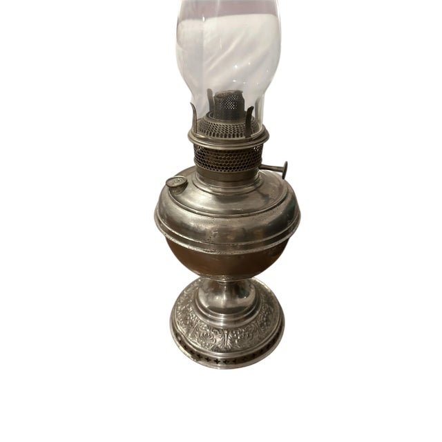 This Bradley & Hubbard oil lamp dates to the late 19th to early 20th century, approximately 1880-1920. During this period,...