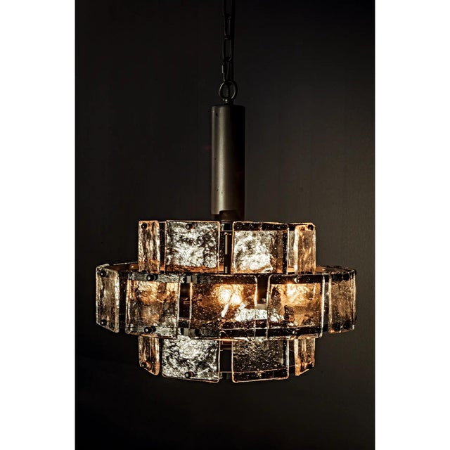 Three tiers of antiqued glass surround the elegant 4 bulb Bergdorf chandelier. To keep the look clean and modern, the...