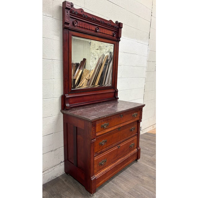 This is a stunning antique late 19th-century Victorian Eastlake marble top walnut dresser with beautifully figured drawer...