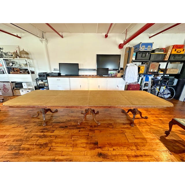 Elegant and substantial Chippendale-style mahogany dining table with three carved pedestal bases and classic ball-and-claw...