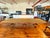 Elegant and substantial Chippendale-style mahogany dining table with three carved pedestal bases and classic ball-and-claw...