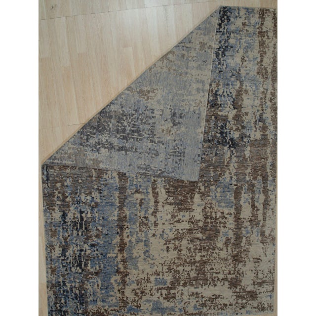 Hand-knotted in wool, this 8 x 10 Celia Louie rug carpet is a refined addition to our contemporary room-size rug...