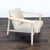 This Four Hands lounge chair features a stylish light wood frame and soft cream upholstery. Its wide seat and angled back...