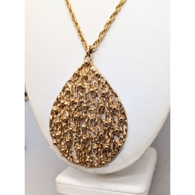 1972-4 Brutalist goldtone openwork with bumps tear drop shaped pendant on a chain necklace with spring ring clasp. Marked...