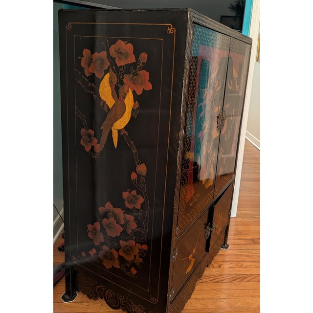 This is a vintage Chinese Chinoiserie black lacquer armoire cabinet, likely produced in the mid-to-late 20th century...