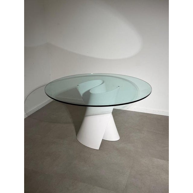 Striking s table designed by xavier lust for mdf italia , featuring an unmistakable sculptural base and a large circular...