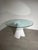 Striking s table designed by xavier lust for mdf italia , featuring an unmistakable sculptural base and a large circular...