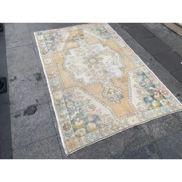 This is a vintage Turkish Oushak rug from the 1960s. The piece was hand-knotted.