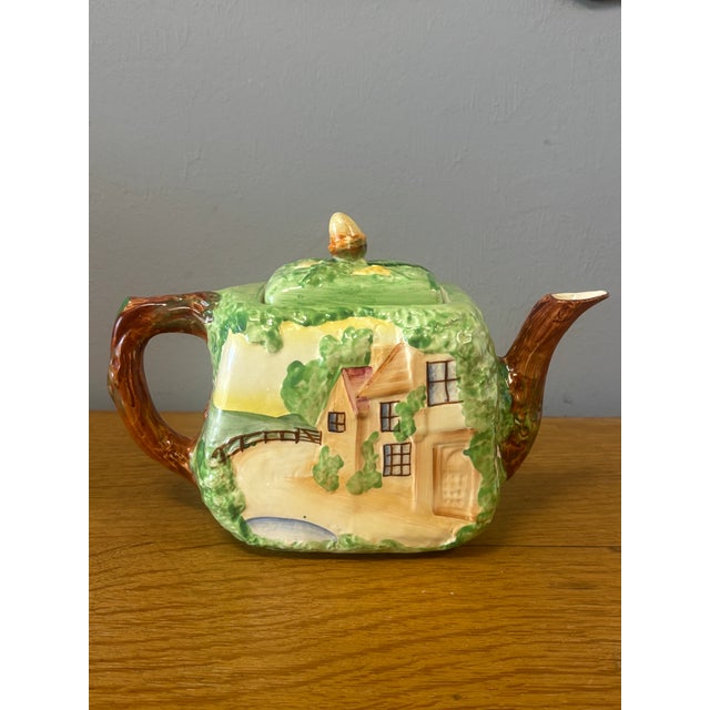 This charming vintage English teapot is a small tableau of the countryside, rendered in ceramic and rich with narrative...