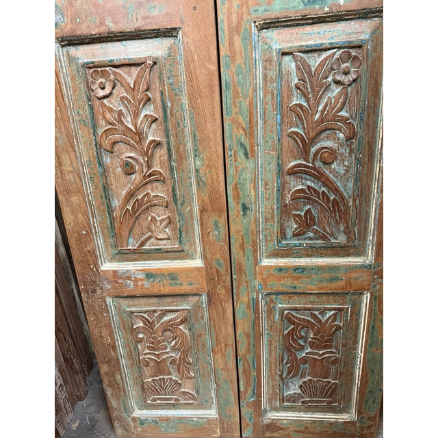 Add character and history to your space with these hand-carved vintage wood double doors featuring a beautifully...