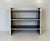 Elegant Italian bookcase from the 1980s, distinguished by a refined contrast between natural parchment and glossy black...