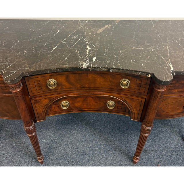 Beautiful Drexel sideboard featuring an elegant serpentine front, richly figured wood grain, and classic neoclassical...