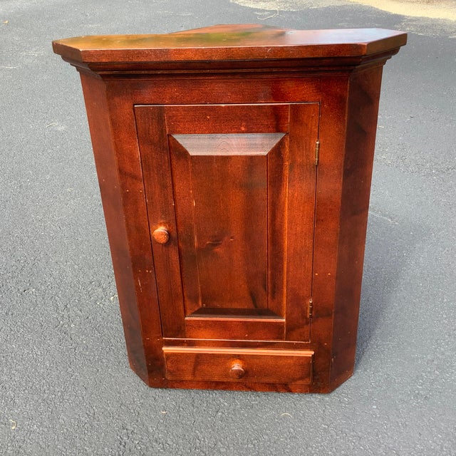 Antique Cherry corner cabinet. Quality abounds from the raised panel door to the drawer and top trim. Rich deep dark color...