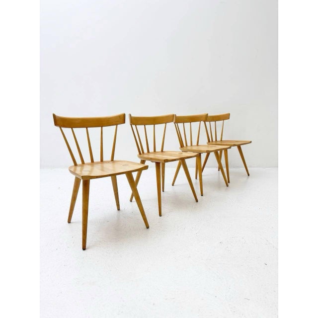 These chairs are a set of mid-century spindle chairs created by the american planner group. They are characterized by...