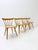 These chairs are a set of mid-century spindle chairs created by the american planner group. They are characterized by...