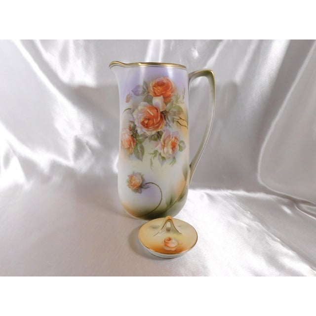 This is a coffee pot with a peach rose design with green leaves. It is marked Made in Germany as shown. The front (handle...
