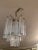 Stylish mid century modern chandelier having glitzy crystal prism columnar bars.