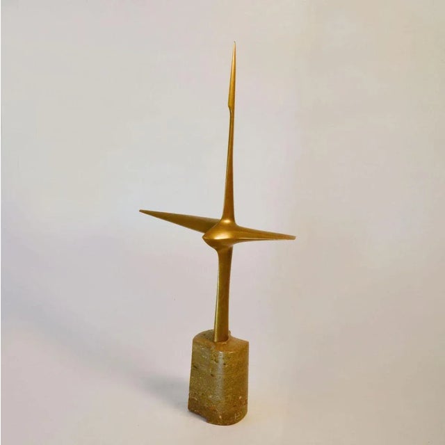 This cast bronze sculpture is in take-off perched on a tower shaped granite rock as a bird must generate enough airflow...