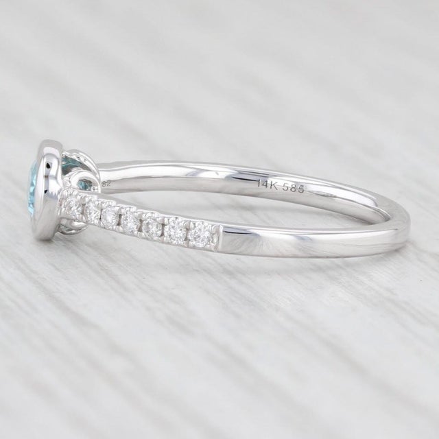 Gem: Natural Zircon - 0.59 Total Carats, Oval Brilliant Cut, Light Blue Color - Natural Diamonds - 0.13 Total Carats,...