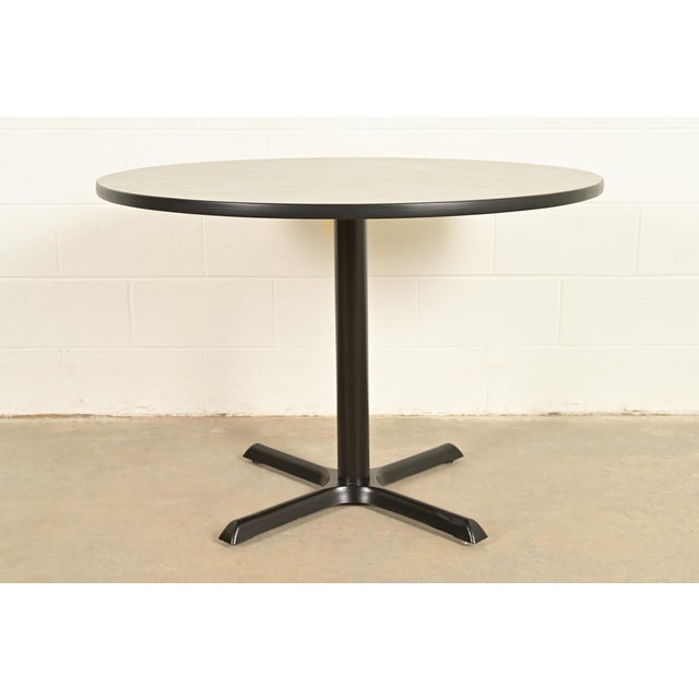 A sleek and stylish Modern or Mid-Century Modern round dining table, breakfast table, bistro table, or game table In the...