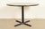 A sleek and stylish Modern or Mid-Century Modern round dining table, breakfast table, bistro table, or game table In the...