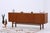 An elegant 1960s sideboard with a warm walnut finish, clean lines, and refined proportions. The integrated bar compartment...