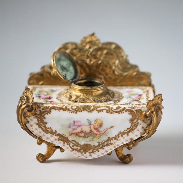An elegant late-19th-century French Sèvres porcelain and gilt-bronze desk inkwell with integrated letter holder, dating to...