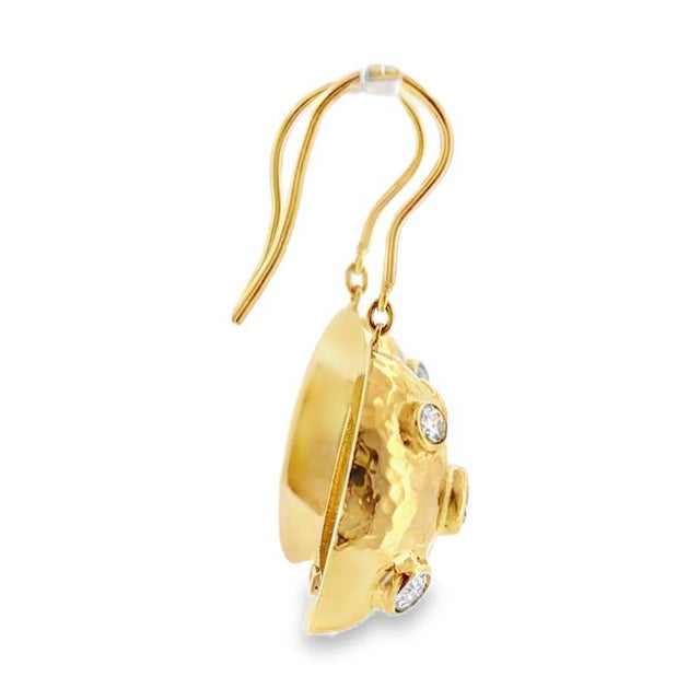 18K yellow gold dangle earrings featuring a hammered oval design set with round cut bezel set diamonds. Diamonds: 1.25...