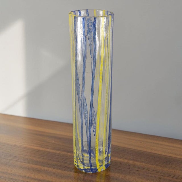 This vintage Attributed Murano art glass vase features a unique striped ribbon motif in blue & Yellow. Hand-blown in...