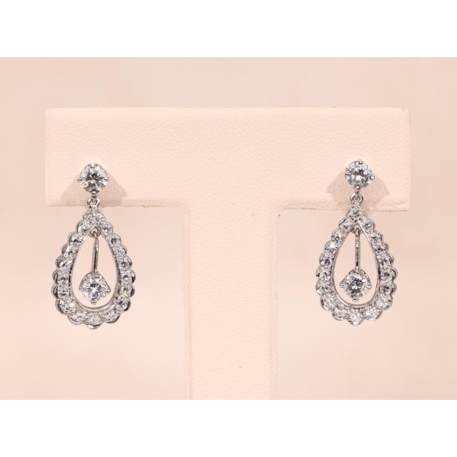 The Menten: Hollywood Glam Era Diamond Dangler Earrings. The earrings feature a 0.25 carat round brilliant cut natural...