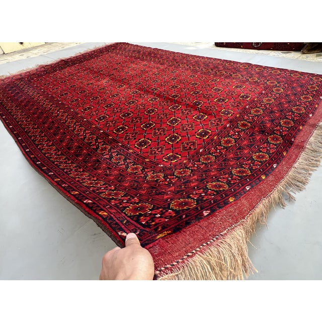 A striking vintage Afghan Ersari "Gülli Gol" tribal rug — hundreds of small rounded quatrefoil flower-guls fill the deep...