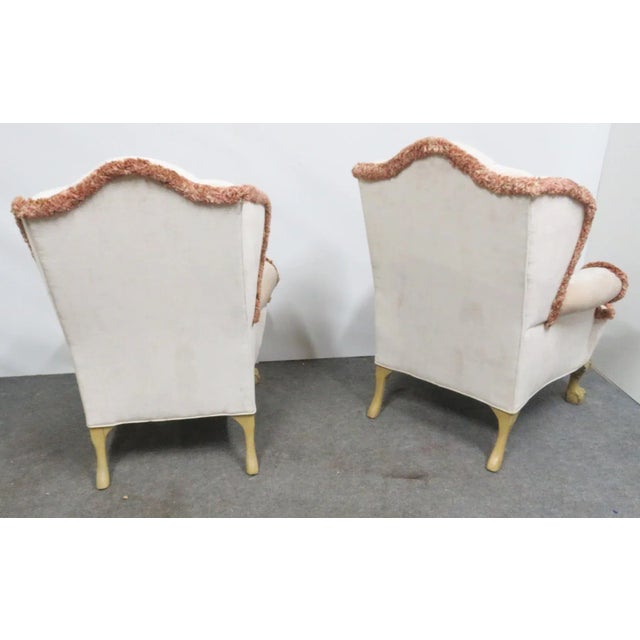 Beige/Cream upholstered with tufted back, Brown/Red accenting fringe. Cream painted ball and claw feet with shell motif at...