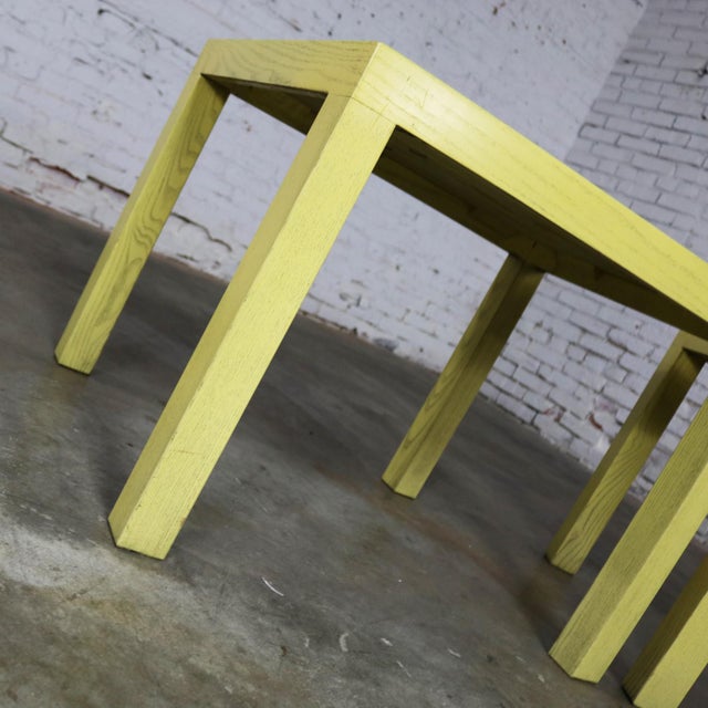 Handsome mid-century modern pair of blonde or cerused oak Parsons end tables or side tables. They are done in the style of...