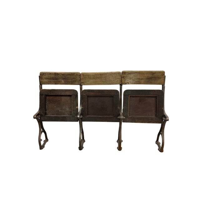 This rare set of antique cinema chairs features solid wooden backs and seats, each topped with studded leather panels that...
