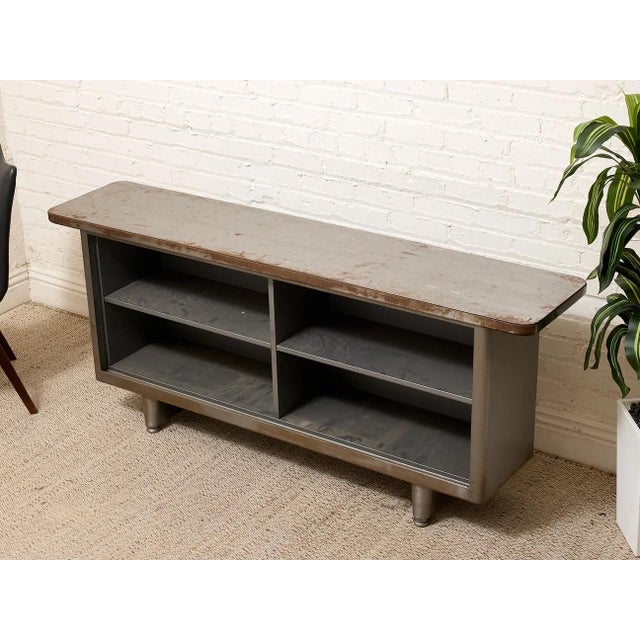Vintage Industrial Metal Open Shelf Console Cabinet is in heavily distressed vintage condition with extensive age- and...